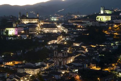 High angle view of city lit up at night