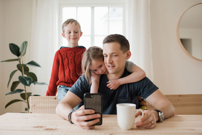 Father and his children having a video call from home in isolation