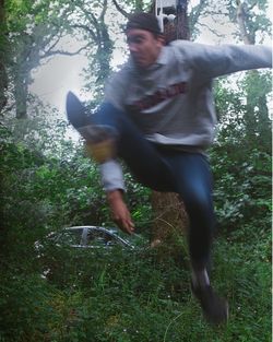 Full length of man on tree in forest