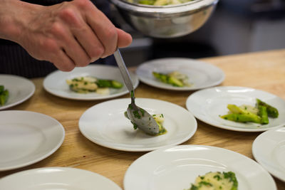 Midsection of person preparing food on table