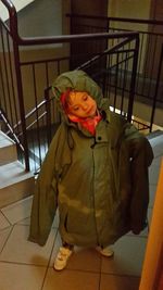 Girl with umbrella on floor at home