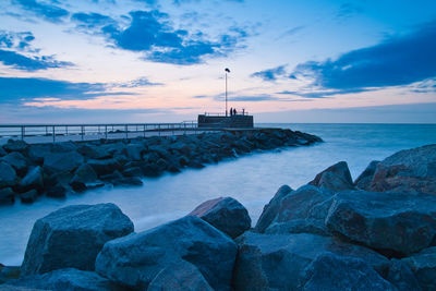 Scenic view of sea against cloudy sky