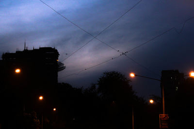 Low angle view of silhouette trees against sky at dusk