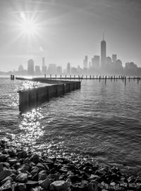Hudson river by cityscape against sky