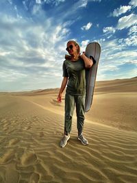 Full length of man standing on sand dune