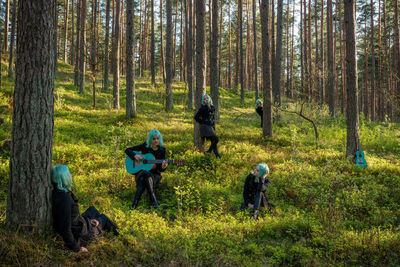 Multiple image of woman against trees in forest