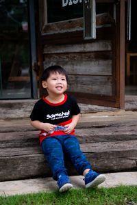 Portrait of boy sitting on staircase