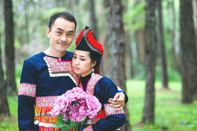 Happy young couple standing on land