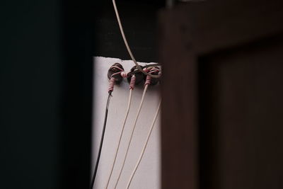 Close-up of ropes hanging on rope against wall