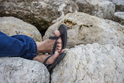 Low section of person holding rock