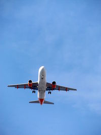 Low angle view of airplane flying in sky