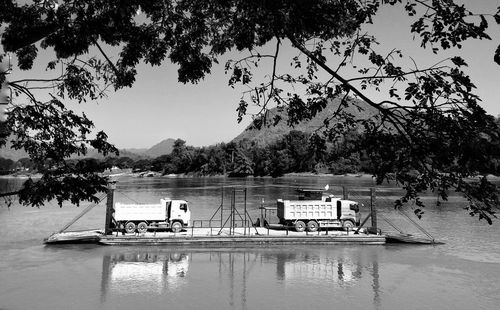 A brace of trucks trucks going home to laos across the mekong river