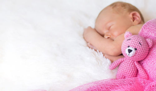 Portrait of cute baby boy lying on snow