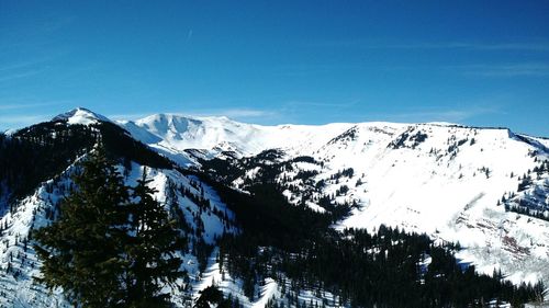 Scenic view of snow covered mountains against clear sky