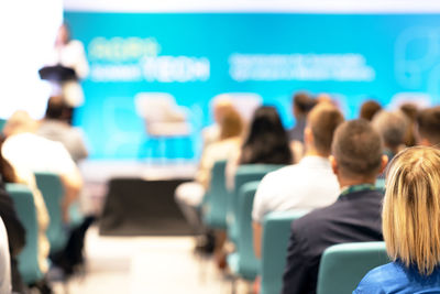 Rear view of participants at business conference or presentation. public speaking event.