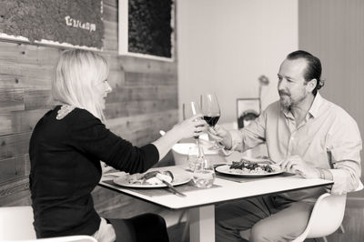 Friends sitting on chair at restaurant