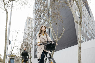 Couple riding e-bikes in the city