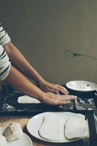 Hands of woman preparing food at home
