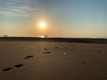 Scenic view of beach against sky during sunset