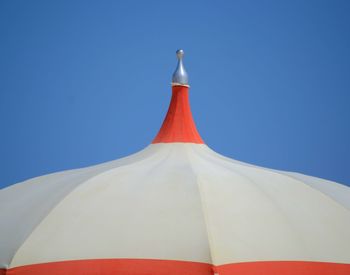 Low angle view of white flag against blue sky