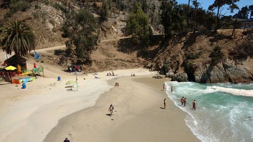 High angle view of people at beach during sunny day