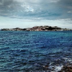 Scenic view of sea against cloudy sky