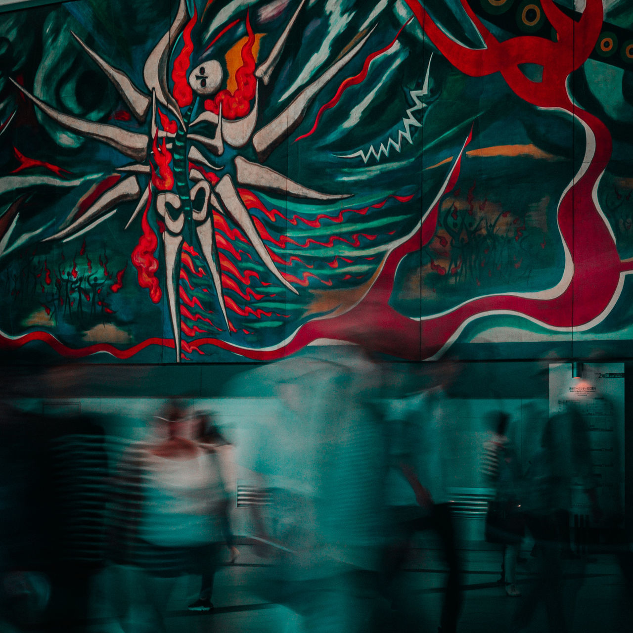 GROUP OF PEOPLE WALKING ON STREET AT NIGHT