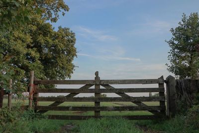 Fence on field against sky