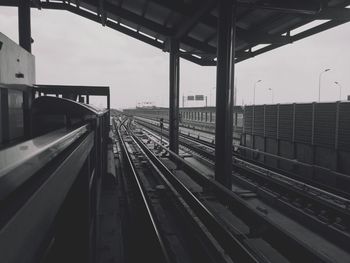 Train at railroad station platform against clear sky