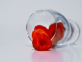 Close-up of strawberry on glass against white background