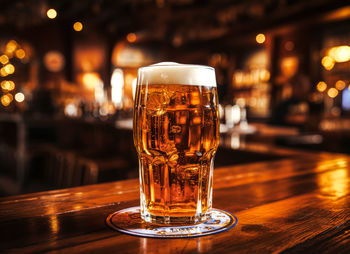 Close-up of beer glass on table