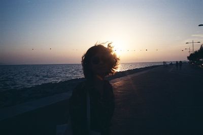 Scenic view of beach against clear sky during sunset