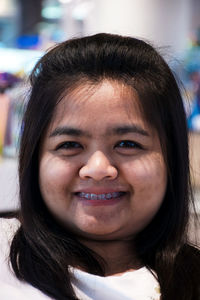 Close-up portrait of smiling young woman