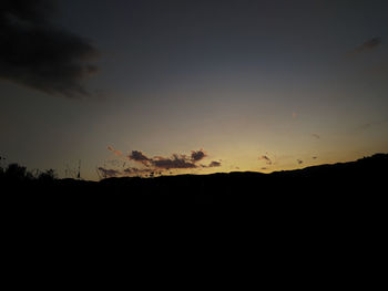 Silhouette landscape against sky during sunset