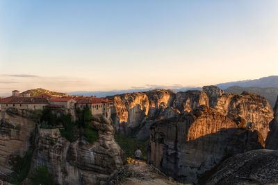 Rock formations and monastery at sunset in meteora, greece