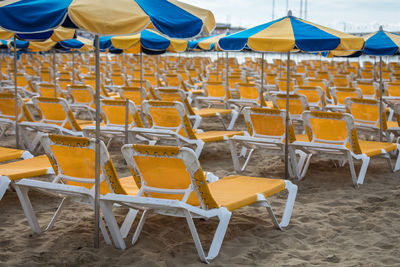 Empty chairs on beach