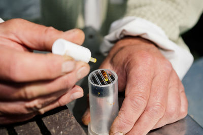 Midsection of man holding electronic cigarette