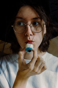 Girl eating jelly eye candy halloween.