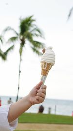 Close-up of hand holding ice cream cone