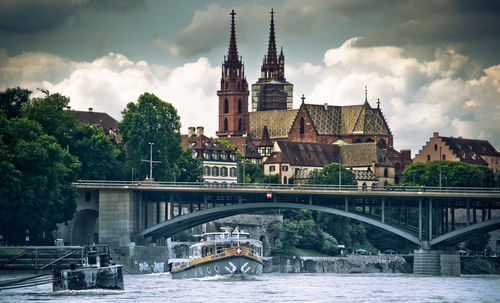 Bridge over river against buildings in city