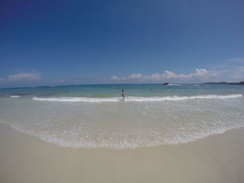 Scenic view of beach against blue sky