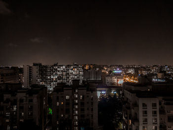 High angle view of illuminated buildings against sky at night