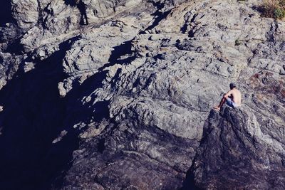 High angle view of people on rock by mountain