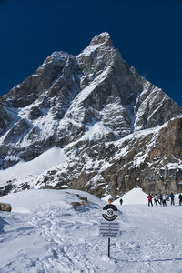 Scenic view of snow covered mountains against clear sky