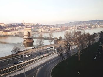 Bridge over river with cityscape in background