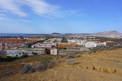 Town by mountain against sky