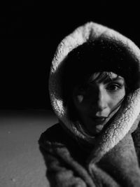 Close-up portrait of young woman wearing hooded jacket