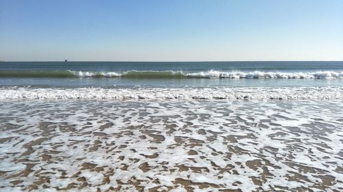 Scenic view of beach against clear sky