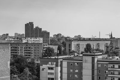 Buildings in city against clear sky