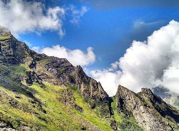 Scenic view of mountains against cloudy sky